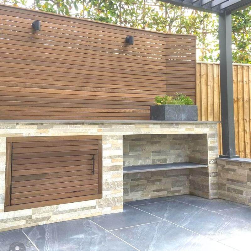 This low-maintenance garden uses Cambia Wood panels, porcelain paving and aluminium pergola.